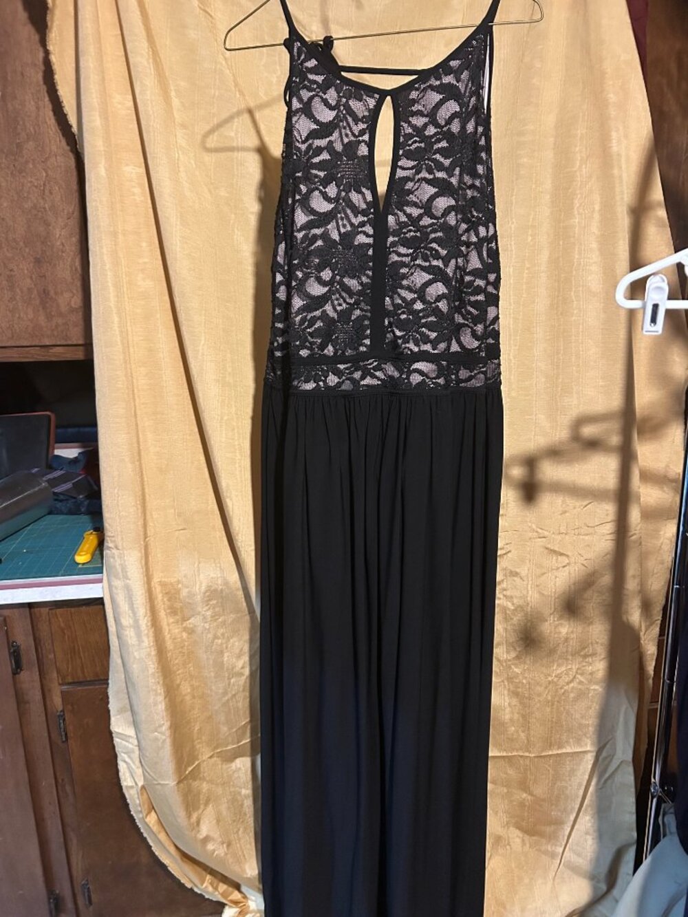 Formal black long maxi dress featuring sleeveless lace bodice with nude tone li